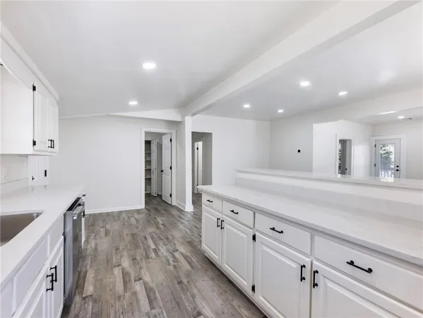 a kitchen with cabinets stainless steel appliances and a sink
