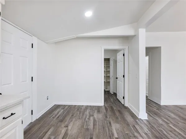 an empty room with a window and a ceiling fan