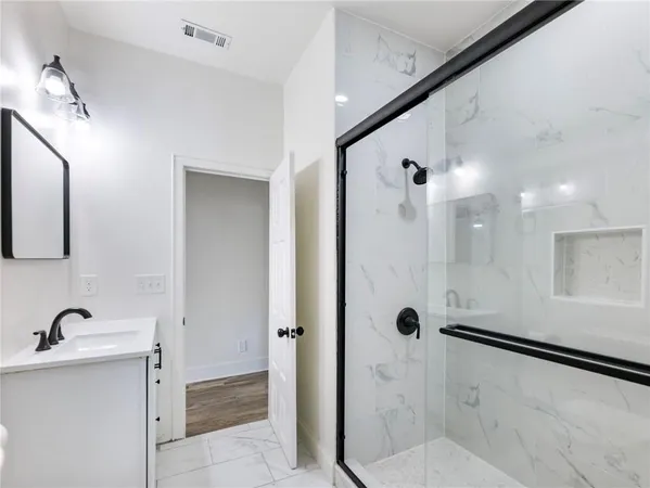 a white toilet sitting next to a bathroom sink