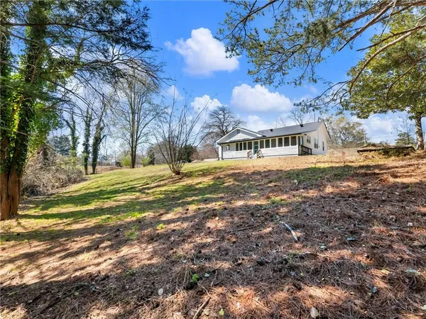 a view of large yard with large trees