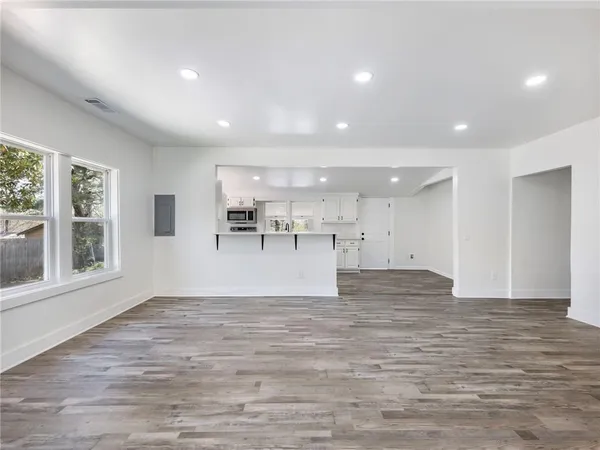 wooden floor in an empty room with a window