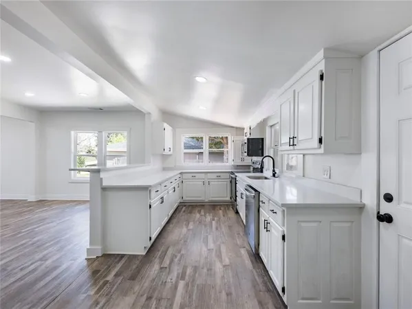 a spacious bathroom with a granite countertop sink