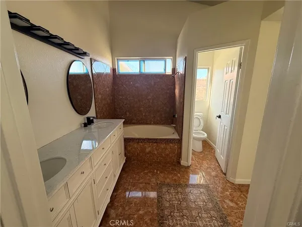 a bathroom with a glass door shower and sink