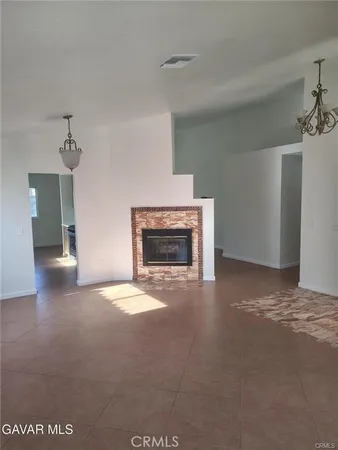 a view of empty room with a fireplace