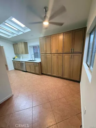 a view of a kitchen with furniture and a ceiling fan