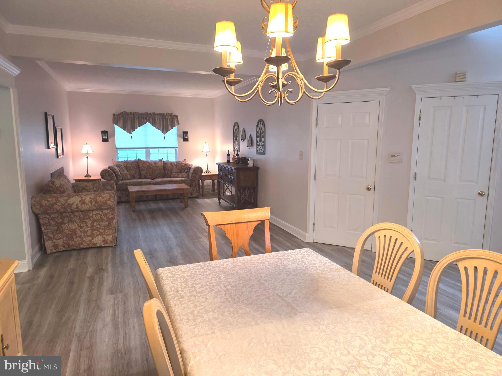 2441 Kemper Road Crofton, MD 21114 - Photo 9 of 63 a living room with furniture chandelier and a wooden floor