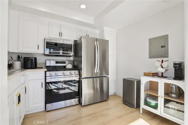 a kitchen with stainless steel appliances a refrigerator stove microwave and sink