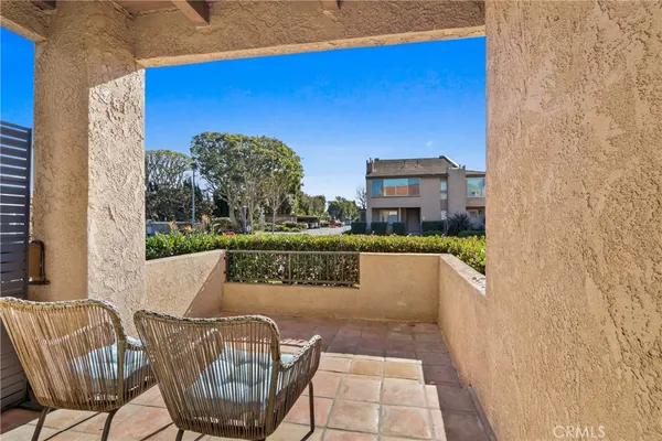 a balcony with table and chairs