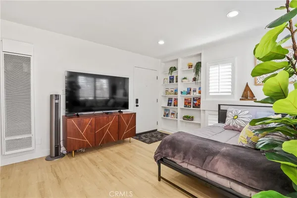 a bedroom with a bed and a flat screen tv