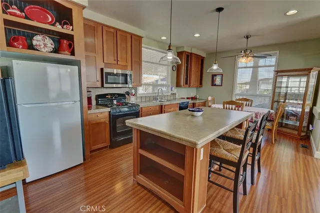 a kitchen with sink stove and wooden floor