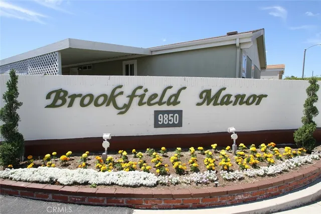 a front view of a house with lots of green space