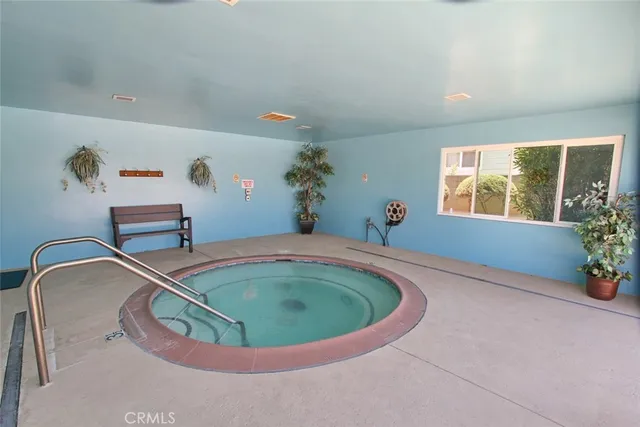 a view of swimming pool with outdoor seating and a pathway