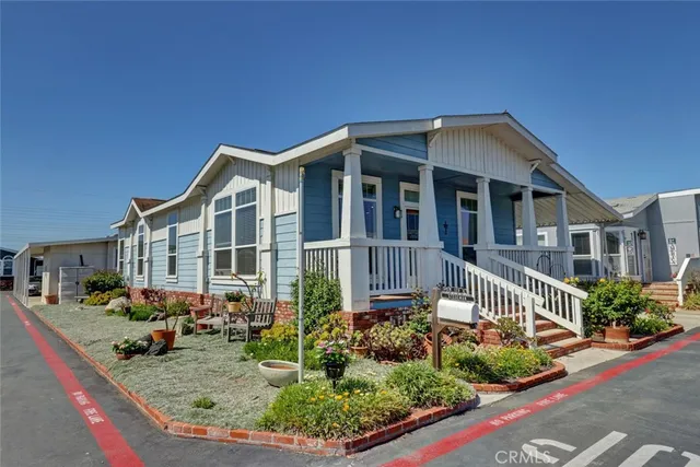 a view of a house with a chairs and table in a patio