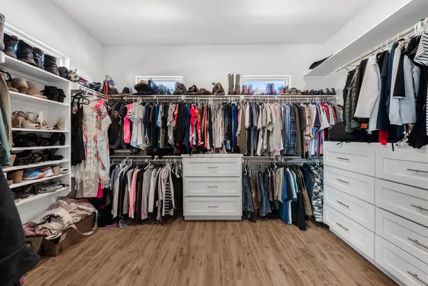 a view of walk in closet with clothes