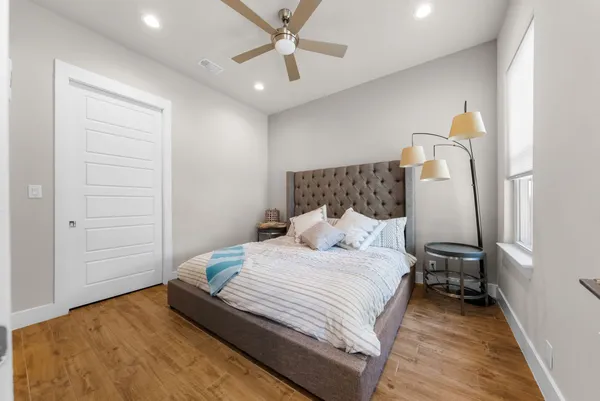 a bedroom with a bed and a chandelier