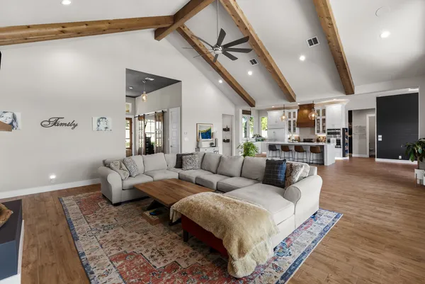 a living room with furniture and a wooden floor