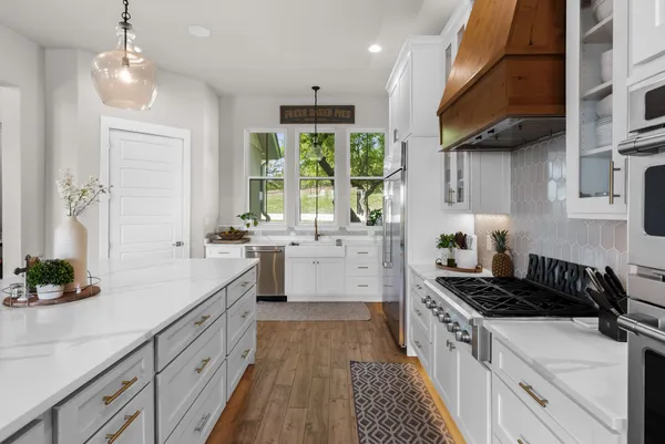 a kitchen that has a sink and a stove in it