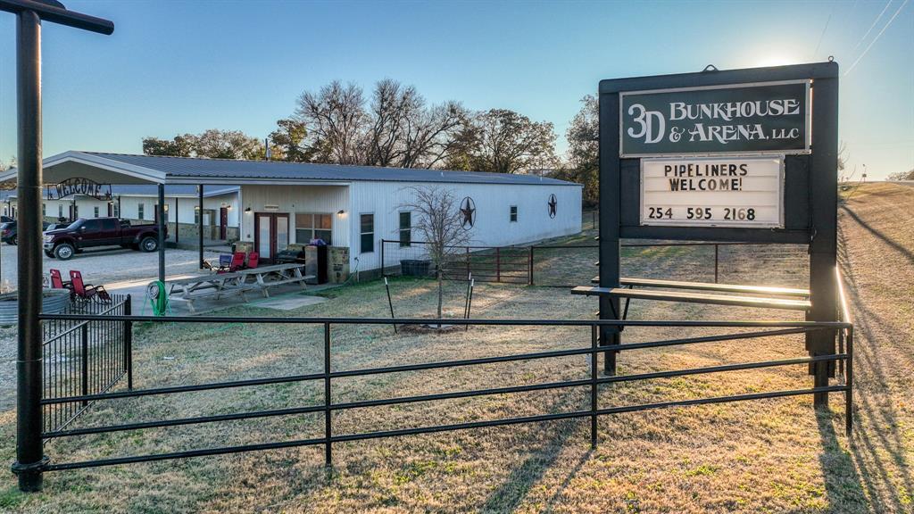 120 Bunkhouse Road Stephenville, TX 76401 - Photo 14 of 40 a view of a house with a small yard and large tree