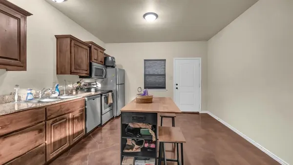 a kitchen with a sink cabinets and wooden floor