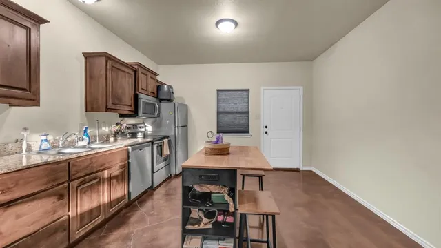 a kitchen with a sink cabinets and wooden floor