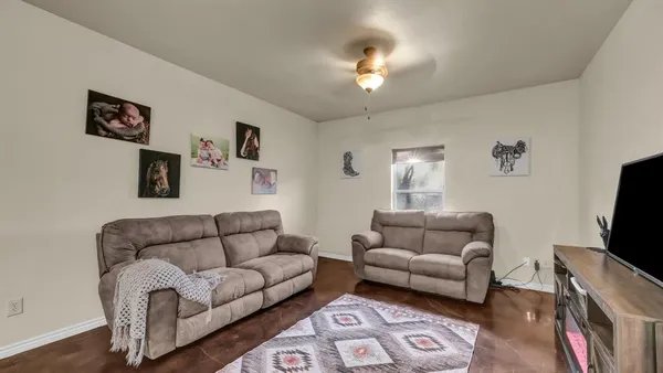 a living room with furniture and a flat screen tv