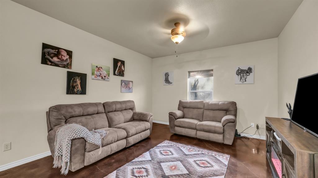 120 Bunkhouse Road Stephenville, TX 76401 - Photo 25 of 40 a living room with furniture and a flat screen tv