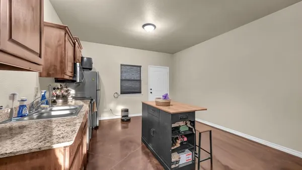 a view of a bedroom with a bed and a ceiling fan