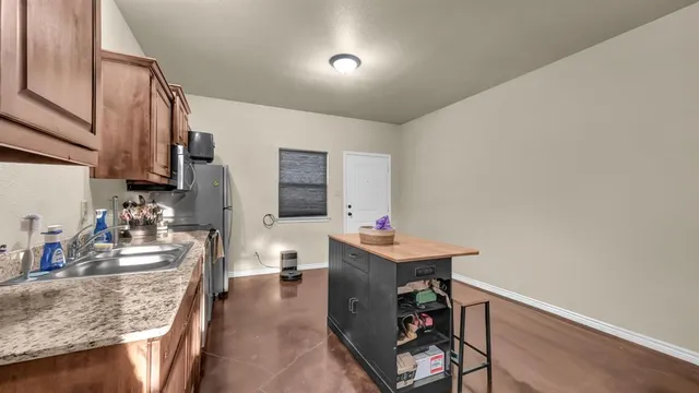 a view of a bedroom with a bed and a ceiling fan