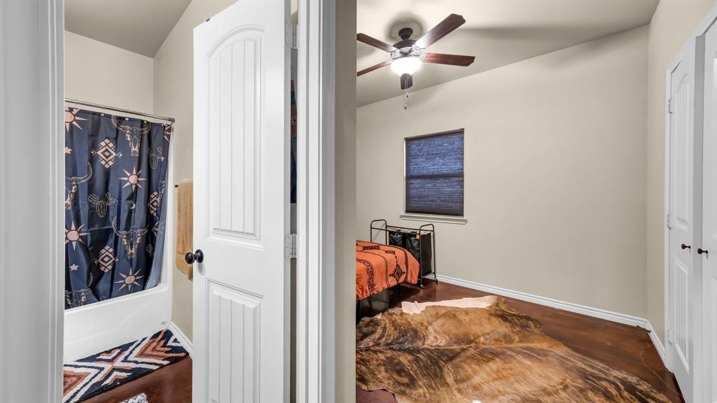 120 Bunkhouse Road Stephenville, TX 76401 - Photo 28 of 40 a view of a bedroom with a bed and a ceiling fan