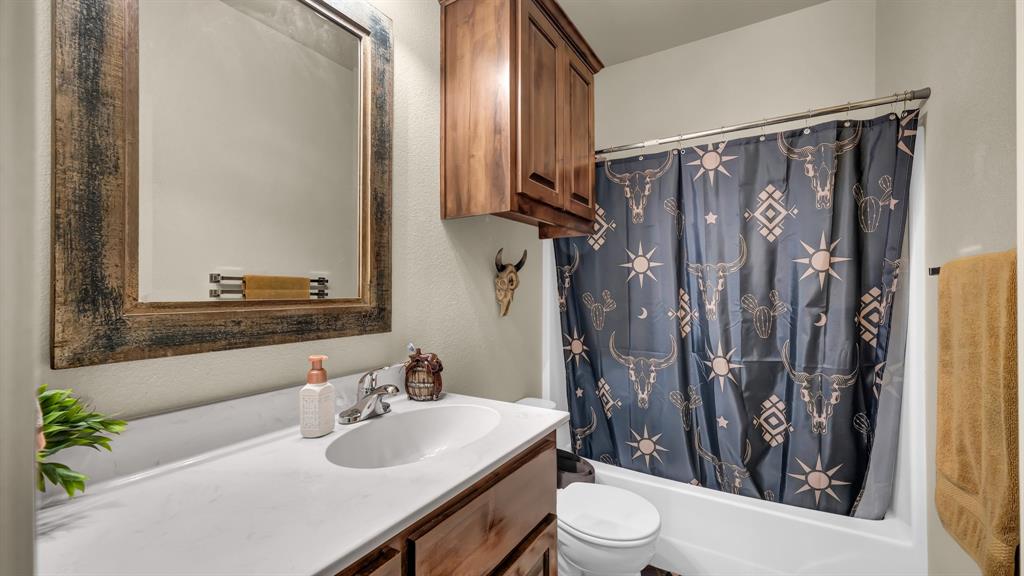 120 Bunkhouse Road Stephenville, TX 76401 - Photo 30 of 40 a bathroom with a sink toilet and shower