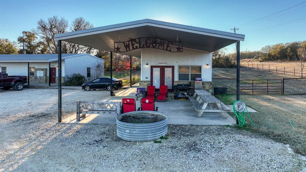 120 Bunkhouse Road Stephenville, TX 76401 - Photo 32 of 40 a view of a chairs and tables in patio