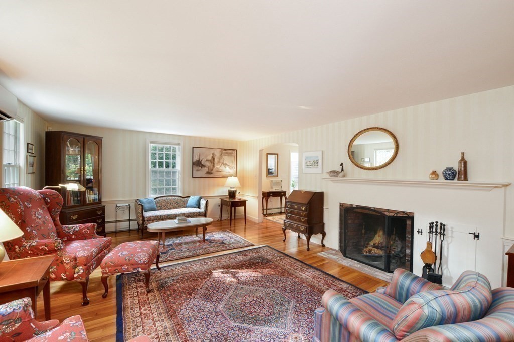 57 Two Ponds Road Falmouth, MA 02540 - Photo 11 of 42 a living room with furniture a clock and a fireplace