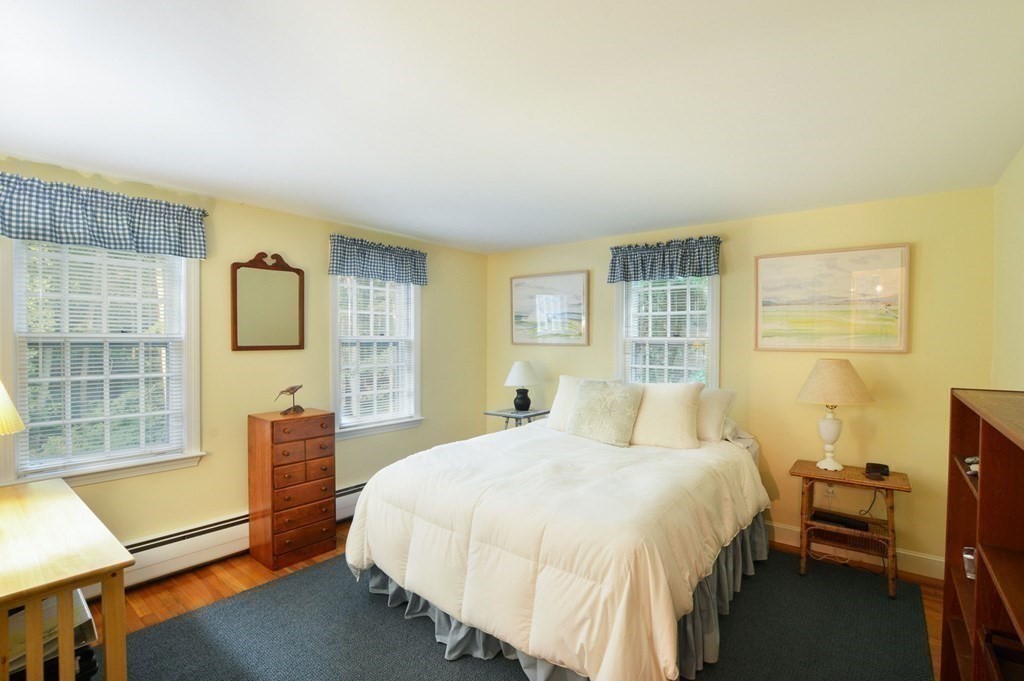 57 Two Ponds Road Falmouth, MA 02540 - Photo 21 of 42 a bedroom with a bed wooden floor and window