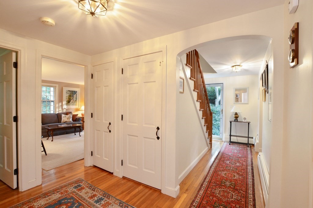 57 Two Ponds Road Falmouth, MA 02540 - Photo 23 of 42 a view of a hallway with a livingroom and a chandelier