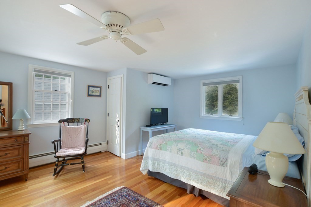 57 Two Ponds Road Falmouth, MA 02540 - Photo 25 of 42 a bedroom with a bed and a chair