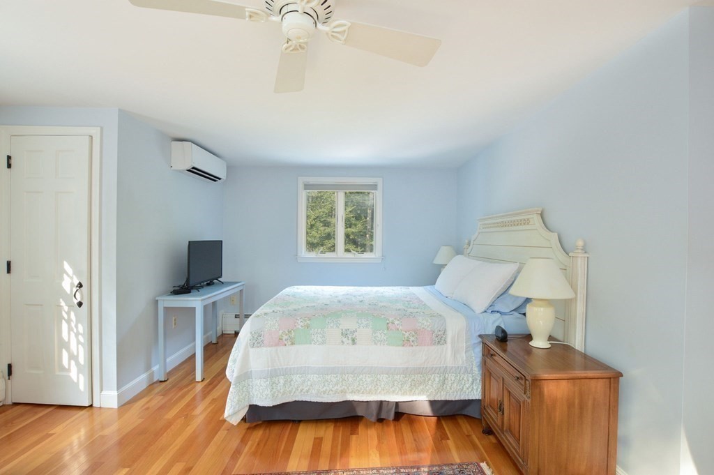 57 Two Ponds Road Falmouth, MA 02540 - Photo 26 of 42 a bed room with a bed tv and a chair