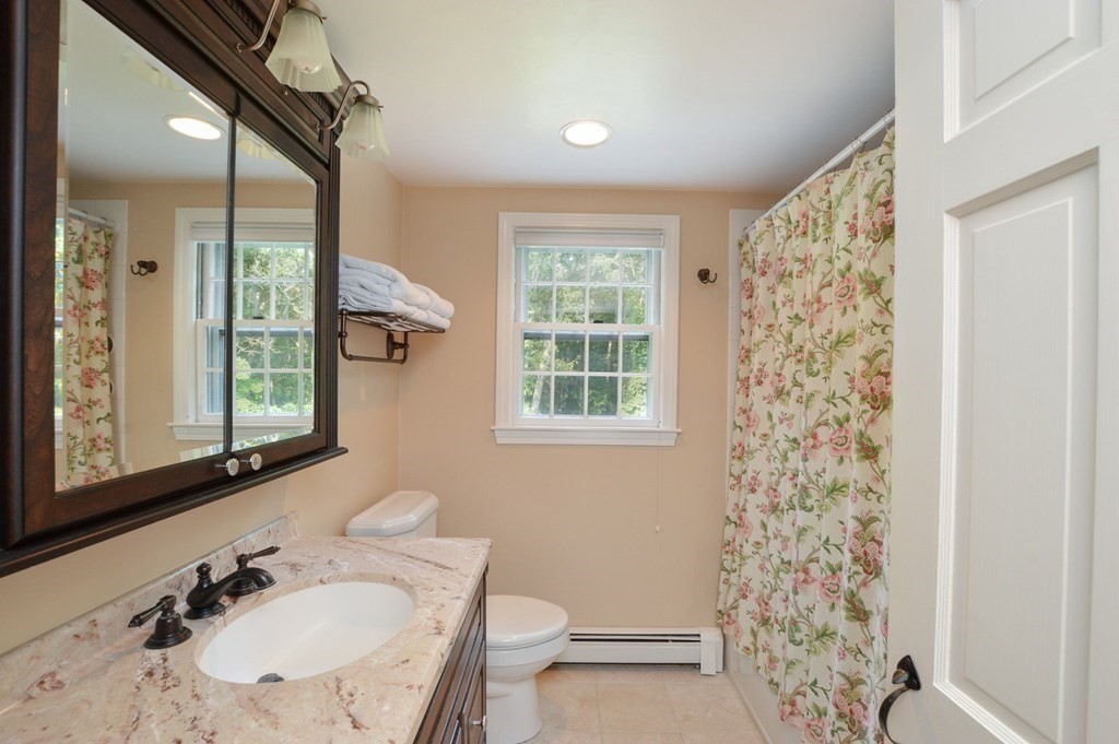 57 Two Ponds Road Falmouth, MA 02540 - Photo 30 of 42 a bathroom with a sink toilet a mirror and shower