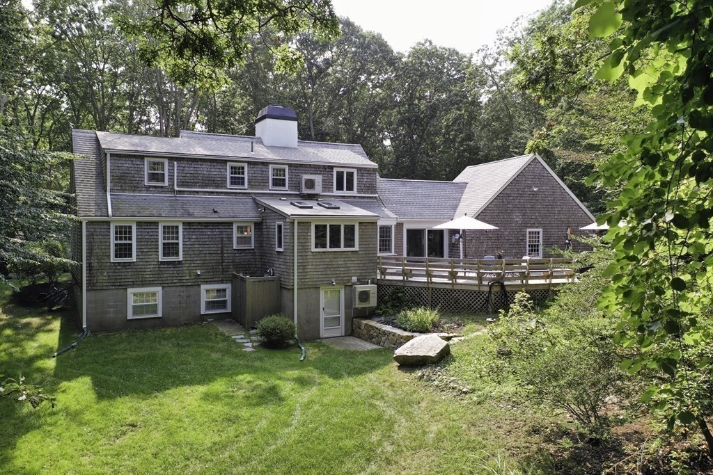 57 Two Ponds Road Falmouth, MA 02540 - Photo 35 of 42 a front view of a house with a yard table and chairs