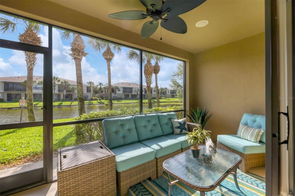 4174 Overture Circle, Unit 519 Bradenton, FL 34209 - Photo 14 of 53 a living room with furniture and a floor to ceiling window