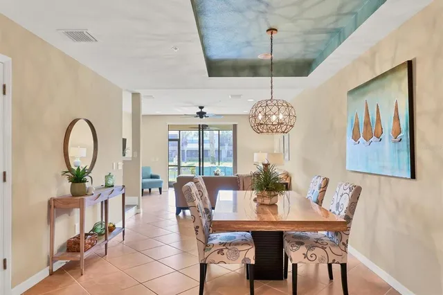 a view of a dining room with furniture and a potted plant