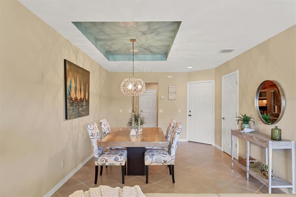 4174 Overture Circle, Unit 519 Bradenton, FL 34209 - Photo 20 of 53 a view of a dining room with furniture and chandelier