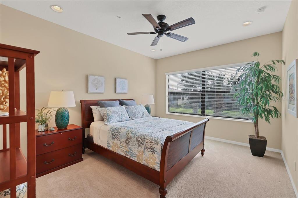 4174 Overture Circle, Unit 519 Bradenton, FL 34209 - Photo 24 of 53 a bedroom with a large bed and a large window