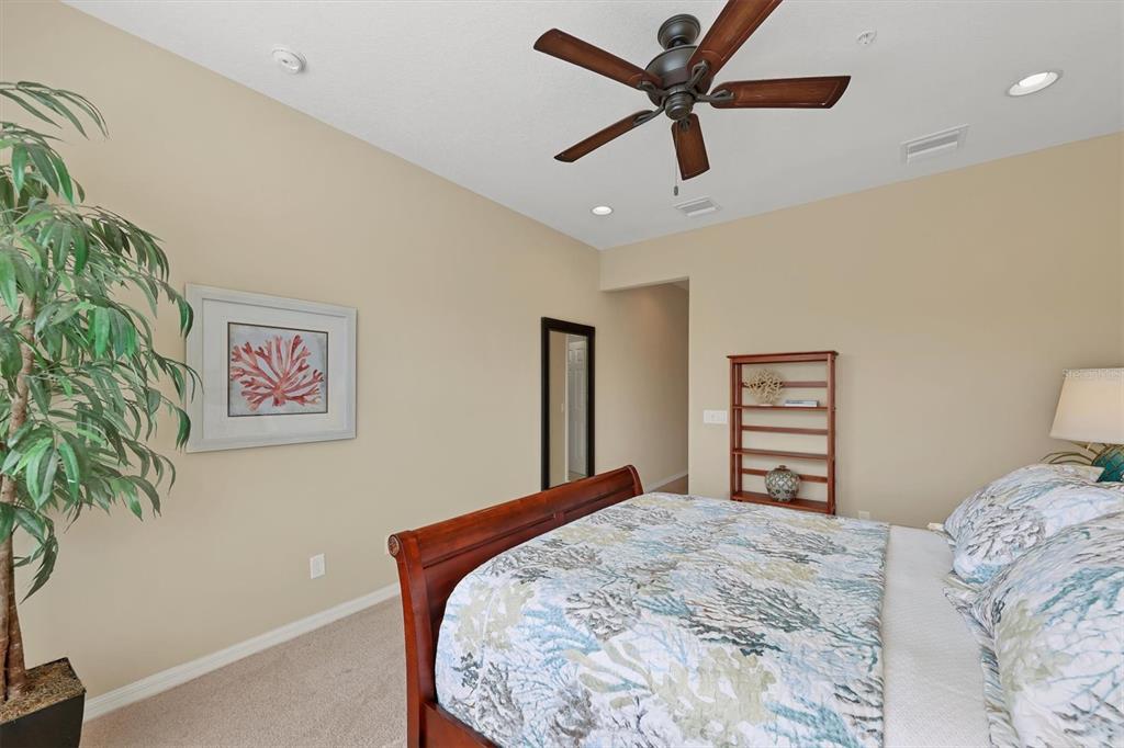 4174 Overture Circle, Unit 519 Bradenton, FL 34209 - Photo 25 of 53 a bedroom with a bed and a painting on the wall