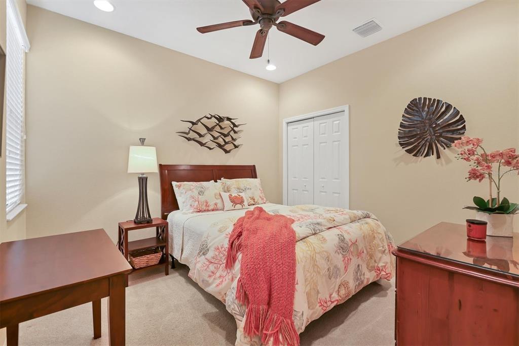4174 Overture Circle, Unit 519 Bradenton, FL 34209 - Photo 29 of 53 a bedroom with a bed and a desk