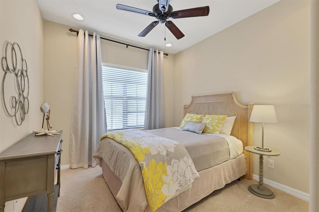 4174 Overture Circle, Unit 519 Bradenton, FL 34209 - Photo 31 of 53 a bedroom with a bed and a chandelier