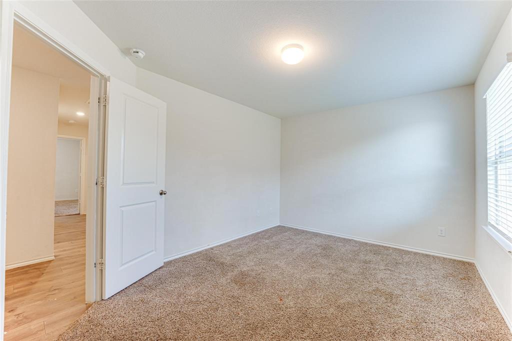 517 Milo Way Royse City, TX 75189 - Photo 19 of 34 Neutral-toned carpeting paired with light-colored walls and trim