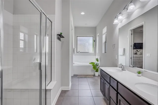 a bathroom with a double vanity sink and a mirror