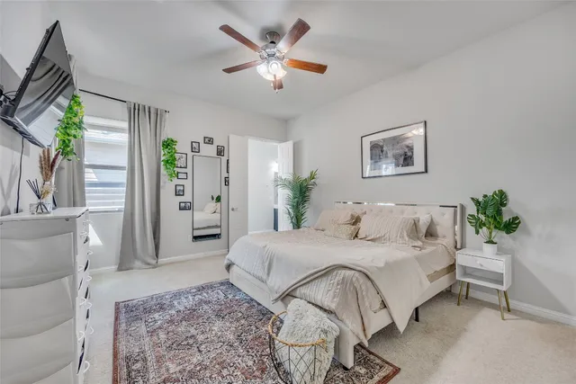 a bedroom with a balcony a bed and a painting on the wall