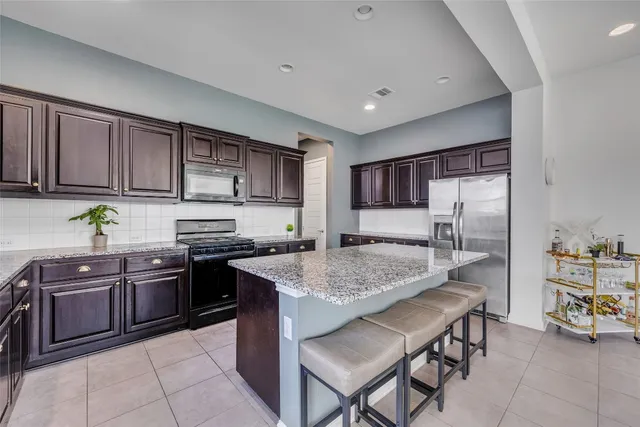 a kitchen with stainless steel appliances granite countertop a sink and cabinets
