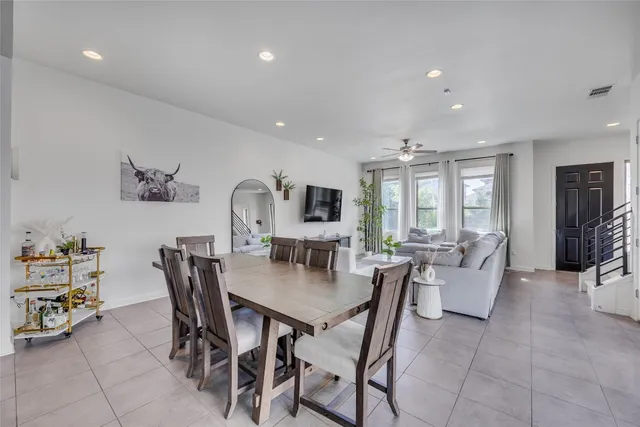 a dining room with furniture and window